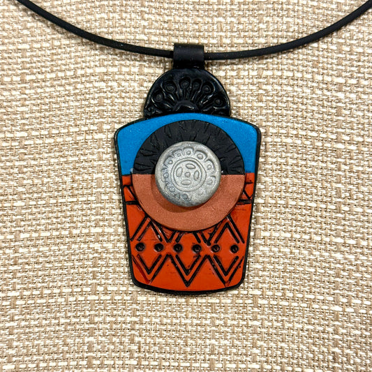 Polymer Clay Textured and Layered Pendant with Teal, Copper, Rust and Black. On a 20" Buna cord with a gold snap closing